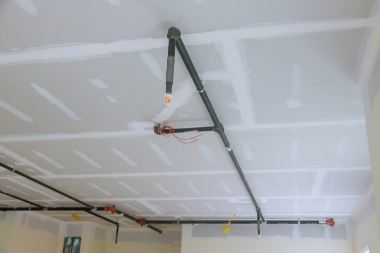 Close-up automatic fire sprinkler on ceiling, RTek Fire Solutions.