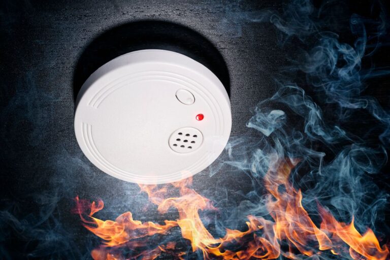 Fire alarm with smoke around it, RTek Fire Solutions.